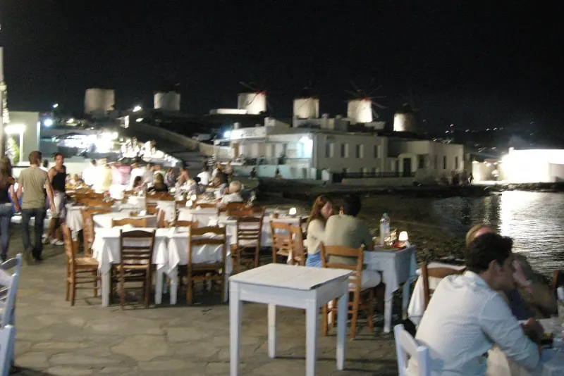 Diners along the Little Venice waterfront at night, Mykonos