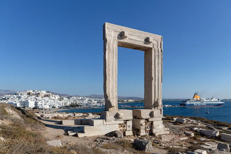 The marble Portara gateway on its islet with Naxos town and the harbor behind