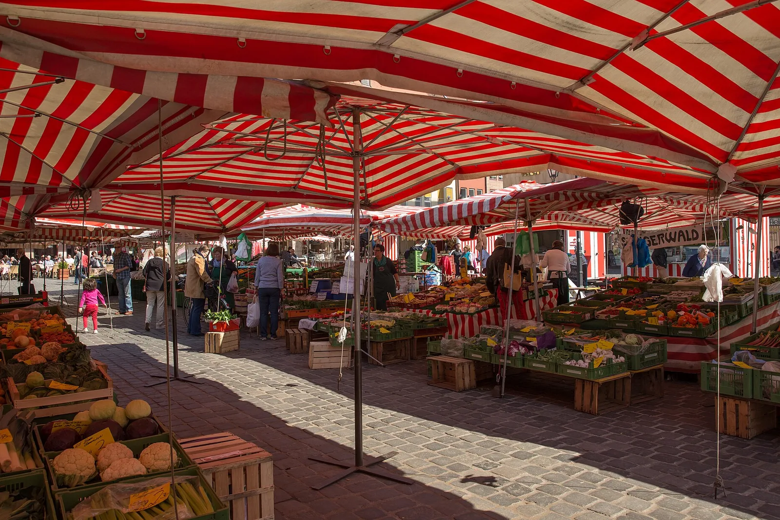 Market stalls with red and white striped roofs on Nuremberg Hauptmarkt