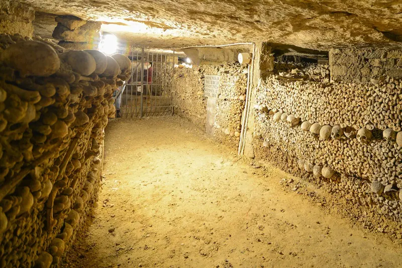 A passage in the Catacombs of Paris lined with stacked bones