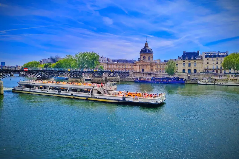 A tour boat on the Seine in front of the Institut de France