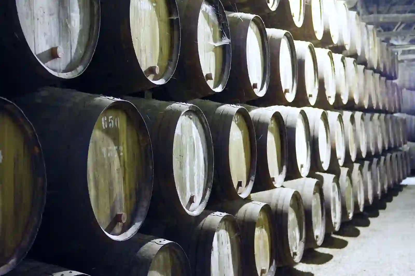 Port wine barrels stacked in a Vila Nova de Gaia cellar