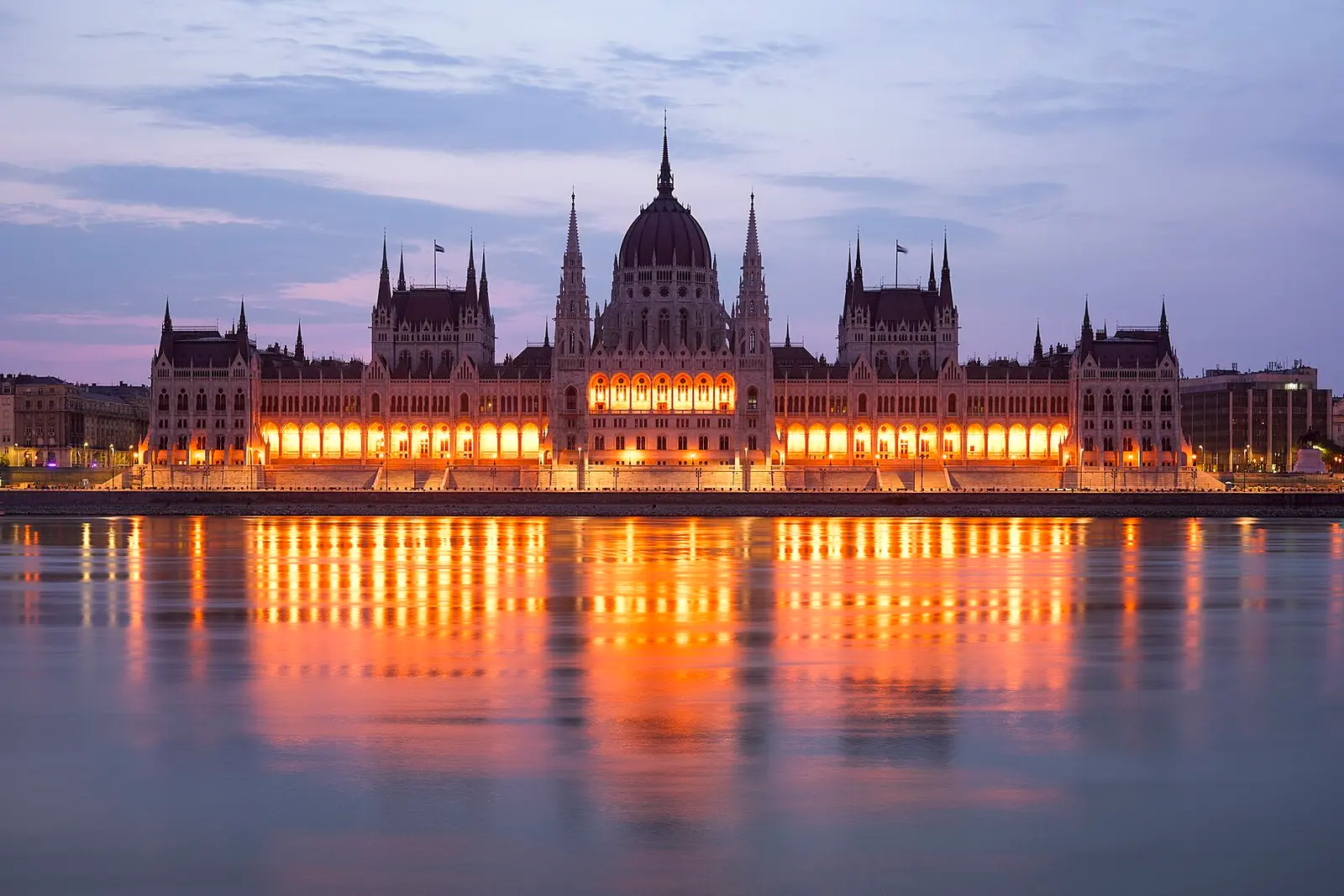 The Hungarian Parliament lit above the Danube at dusk