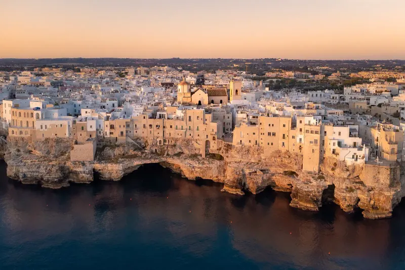 Polignano a Mare old town on its limestone cliffs above the sea at dawn