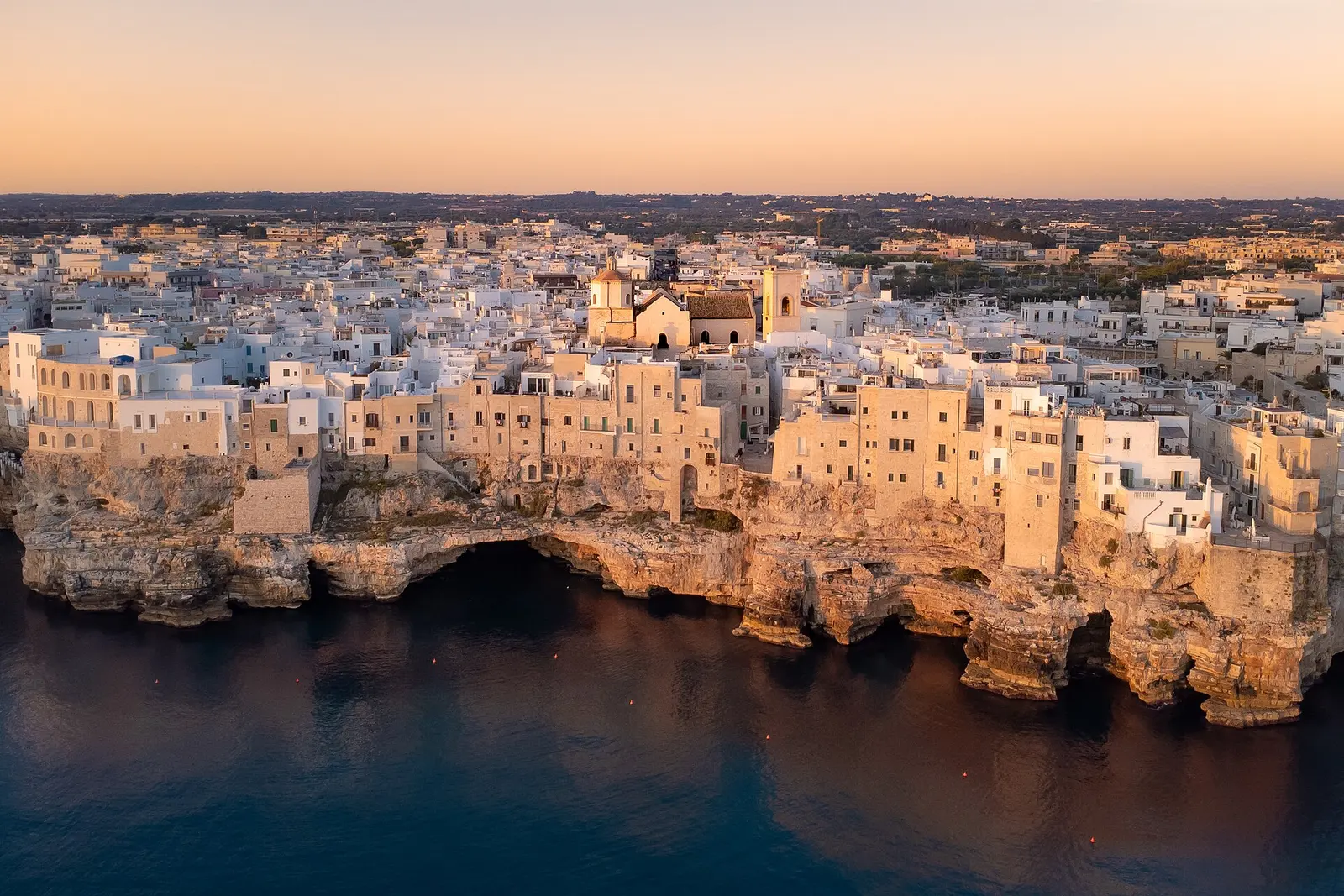 Polignano a Mare old town on its limestone cliffs above the sea at dawn