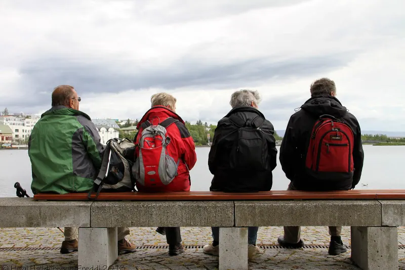 People sitting by the waterfront in Reykjavik