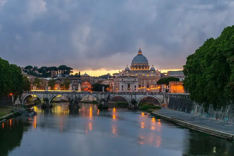 The Tiber at dusk with the dome of St. Peter's in the distance