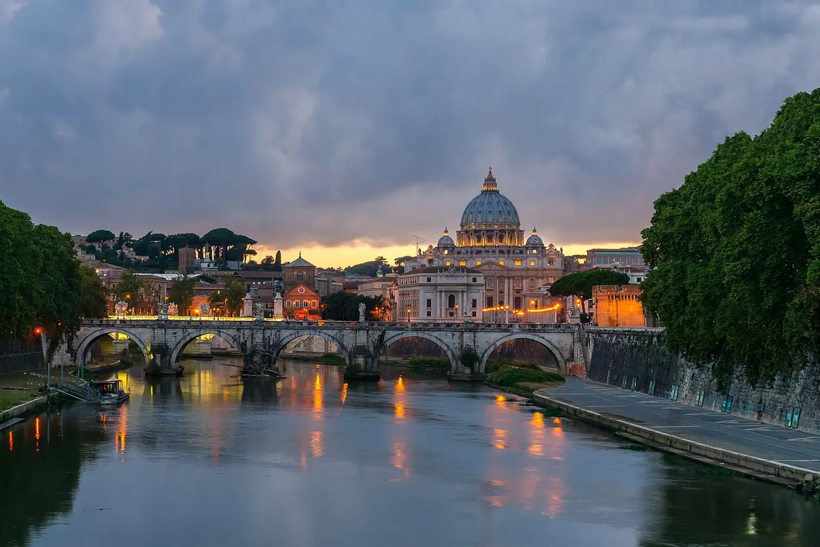 The Tiber at dusk with the dome of St. Peter's in the distance