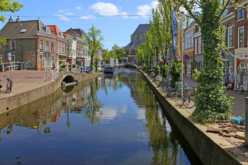 A canal lined with houses in Delft