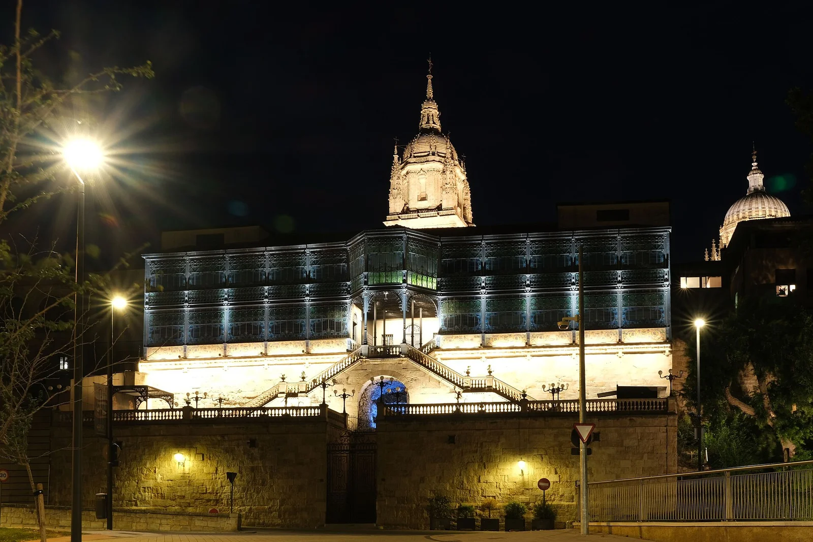 The stained glass facade of Casa Lis lit at night