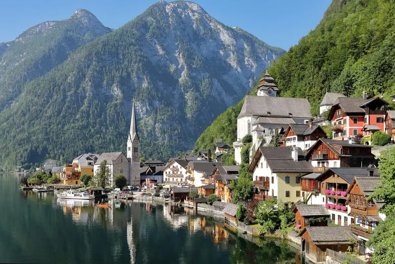 Houses and church spire of Hallstatt beside the lake