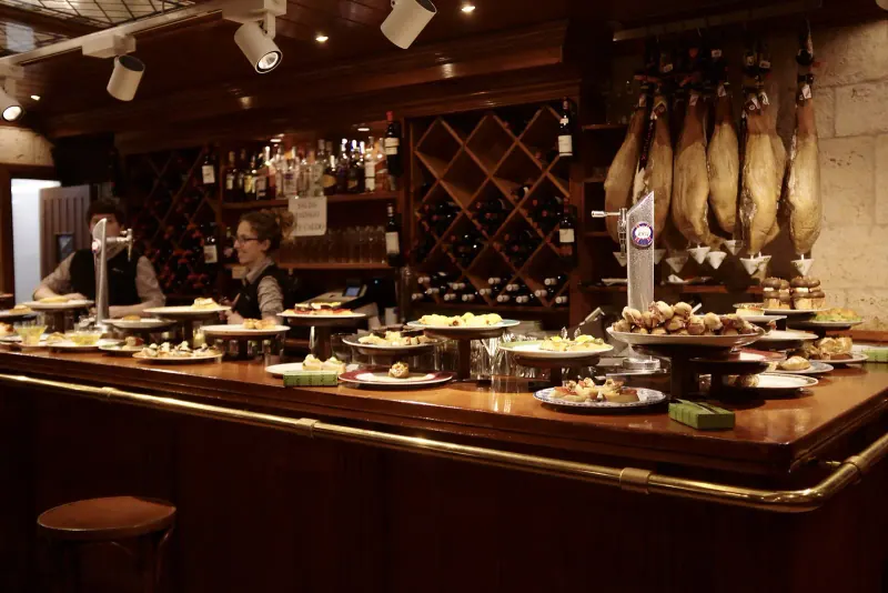 Pintxos lined along a bar counter in San Sebastian