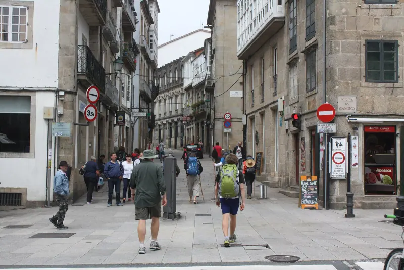 Pilgrims arriving at the Porta do Camino, Santiago