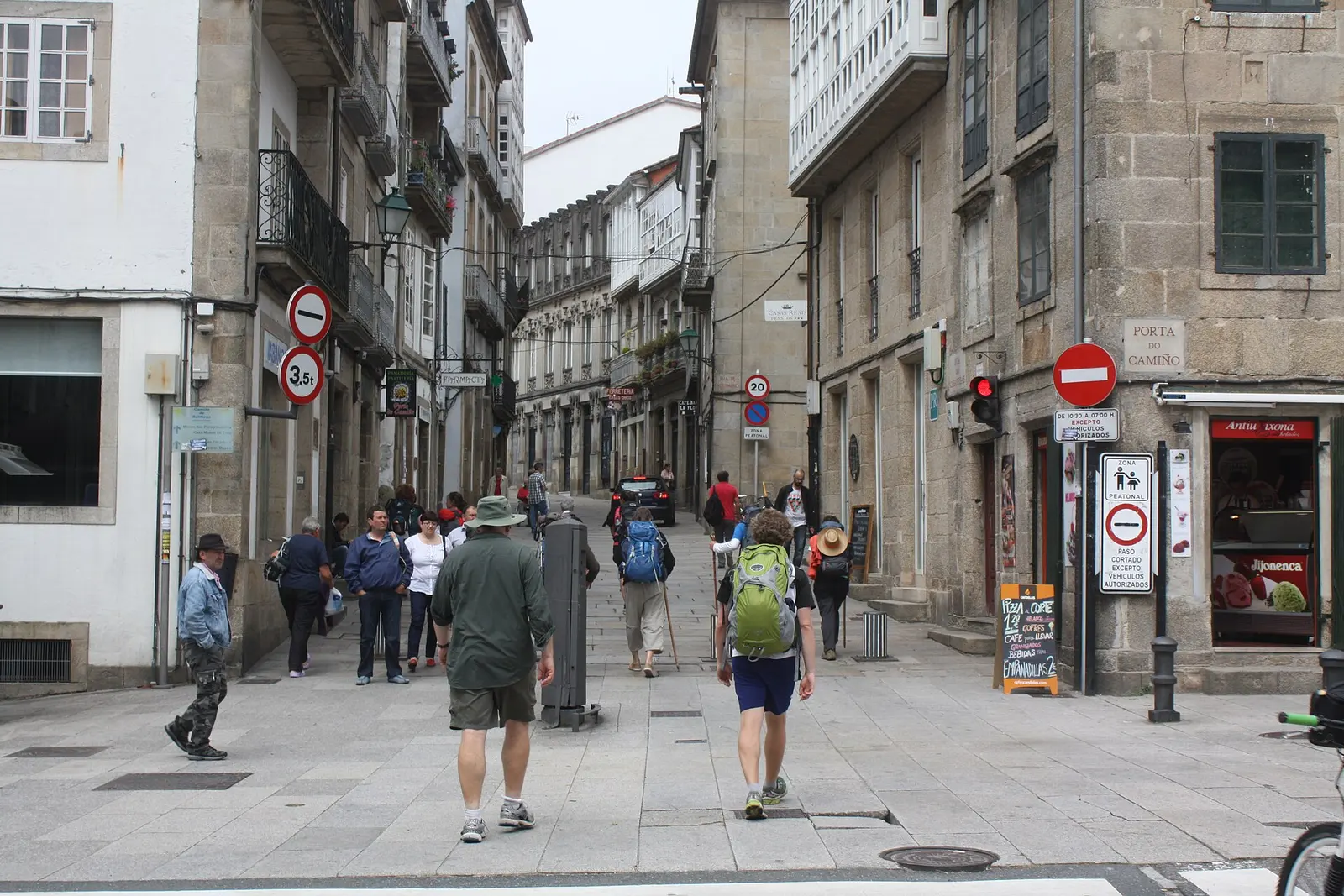 Pilgrims arriving at the Porta do Camino, Santiago