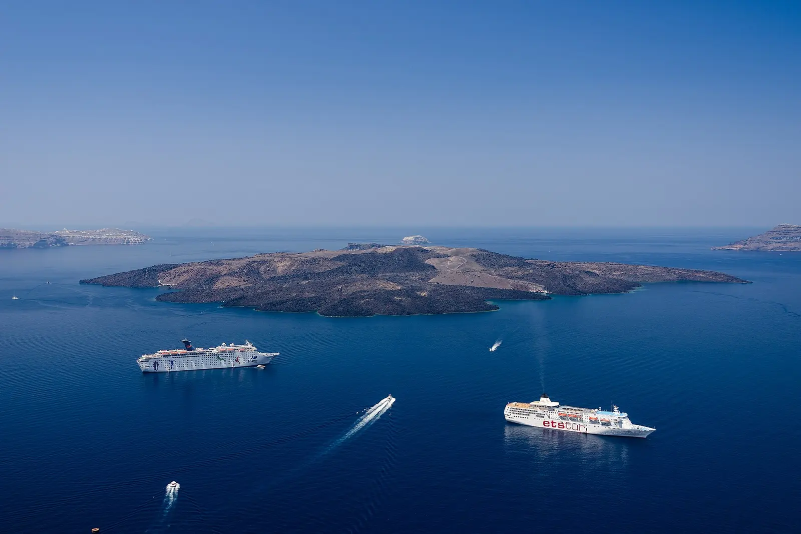 Boats on the blue water inside Santorini's caldera