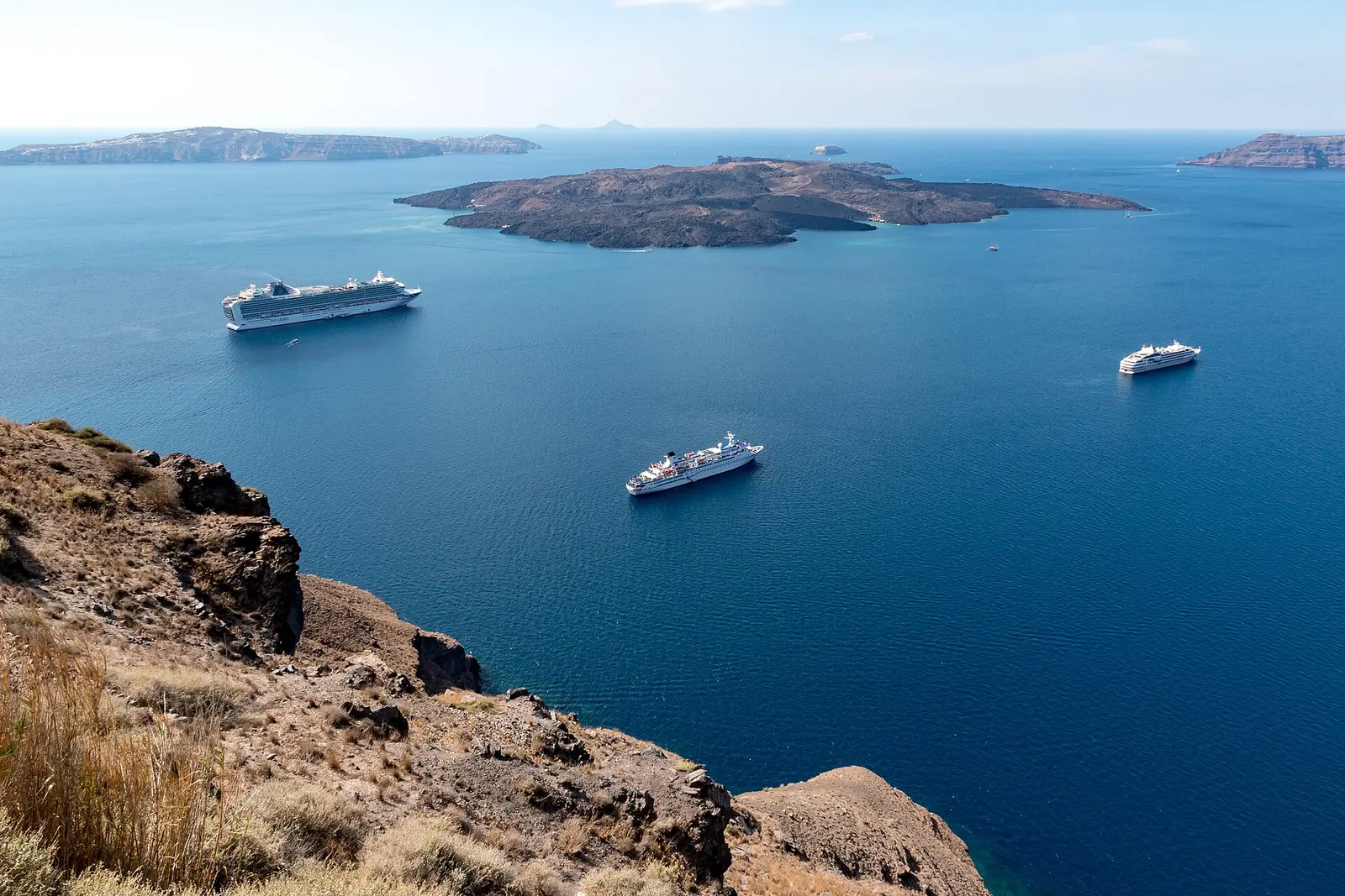 Cruise ships anchored inside Santorini's flooded caldera