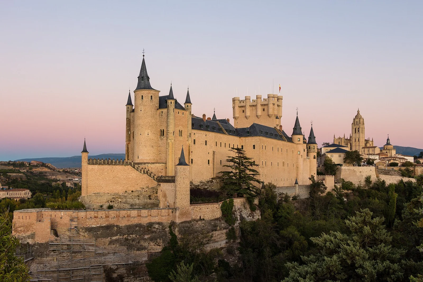 The Alcazar of Segovia at dusk seen from the valley below