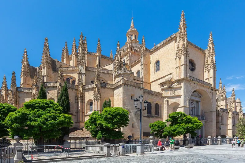 Segovia Cathedral's Gothic facade and pinnacles rising above the square