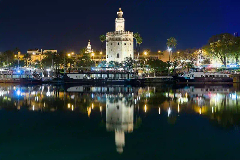 Torre del Oro on the Guadalquivir river bank in Seville at night