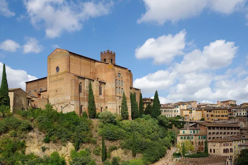 Stone houses and cypresses inside Siena's walls