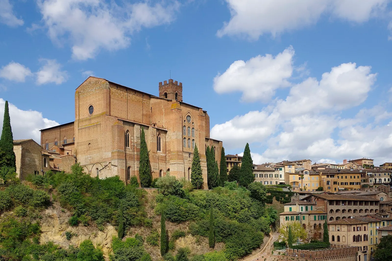 Stone houses and cypresses inside Siena's walls