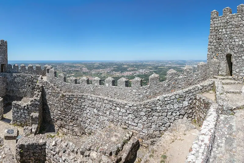 Stone towers and battlements of the Castle of the Moors with the plain stretching to the horizon