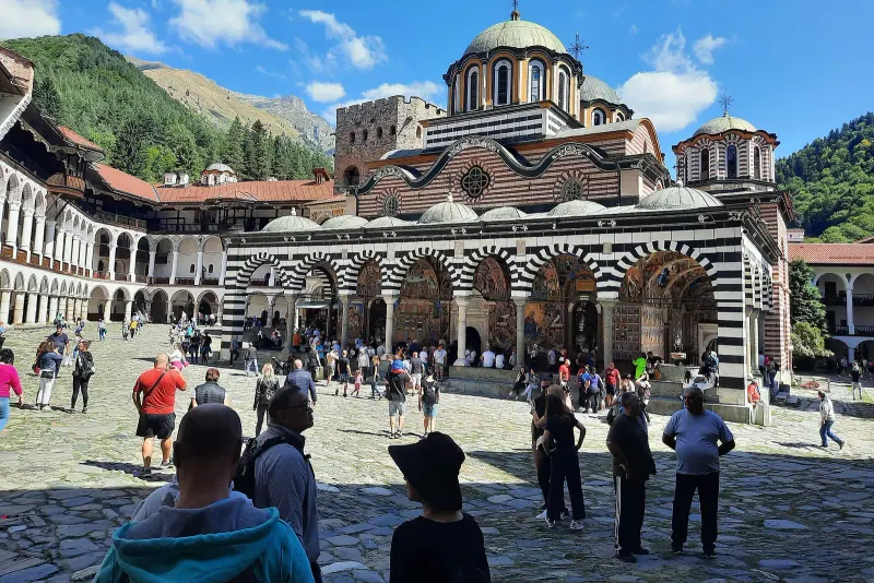 The striped arches of Rila Monastery's courtyard