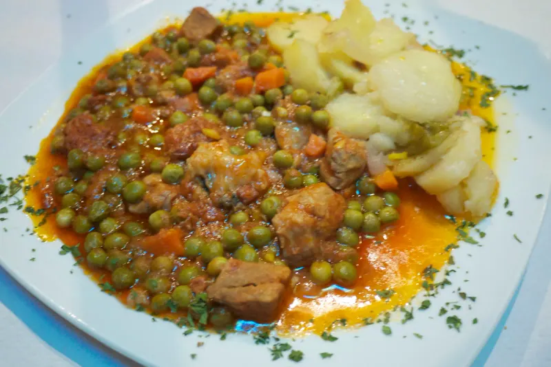 Carcamusas, Toledo's signature pork and tomato stew, served in a clay dish