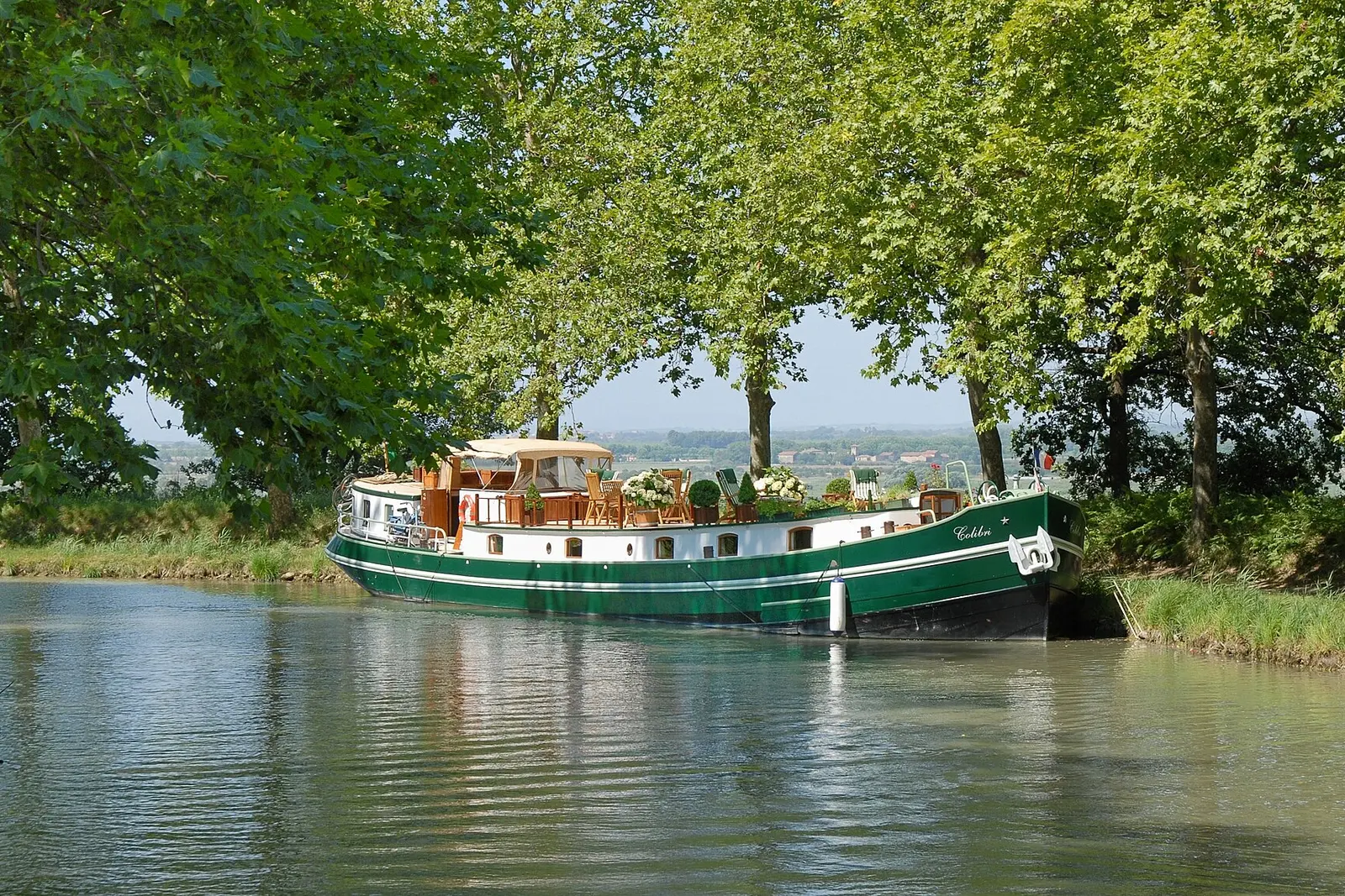A canal boat under the plane trees of the Canal du Midi