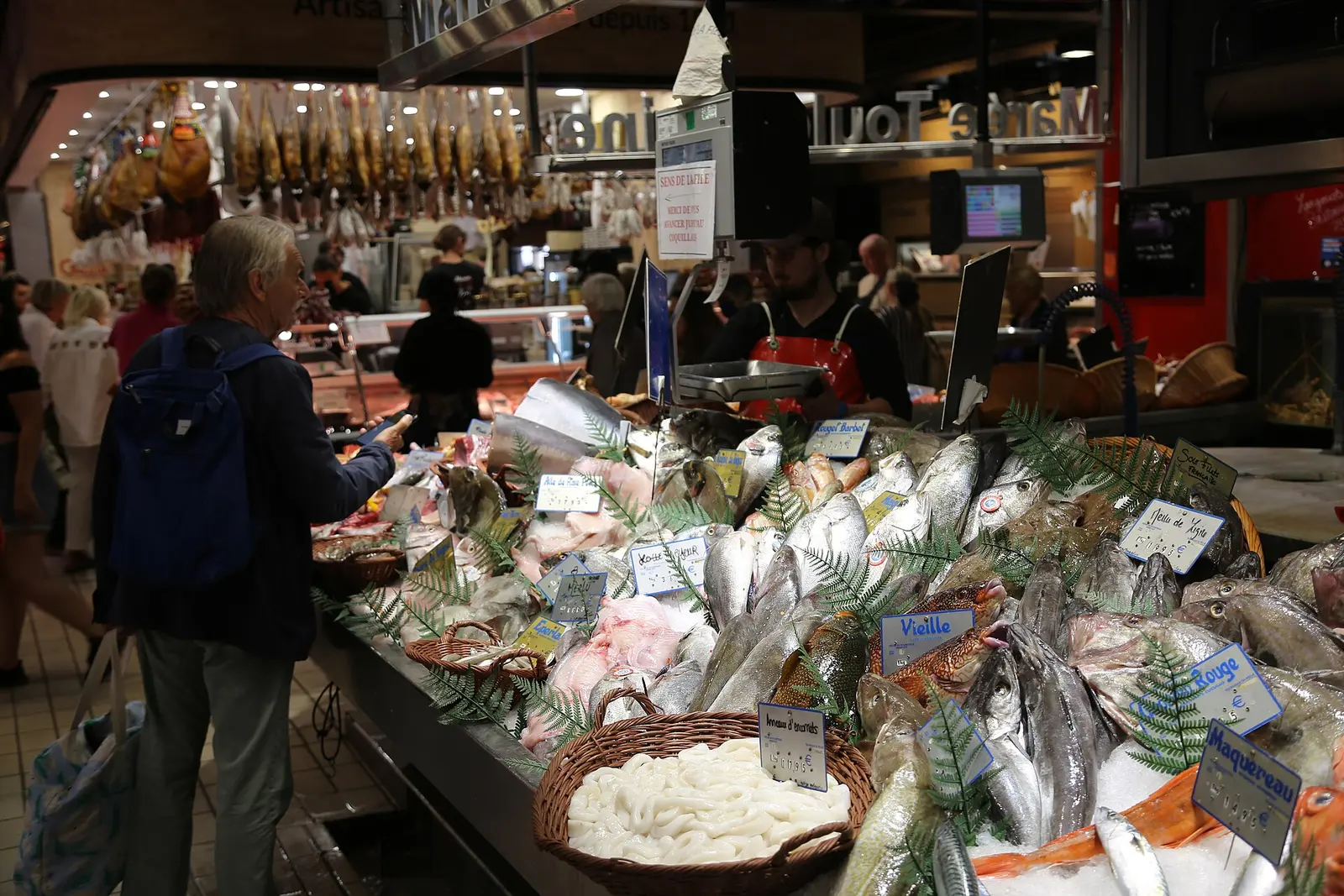 Produce stalls inside the Marche Victor Hugo