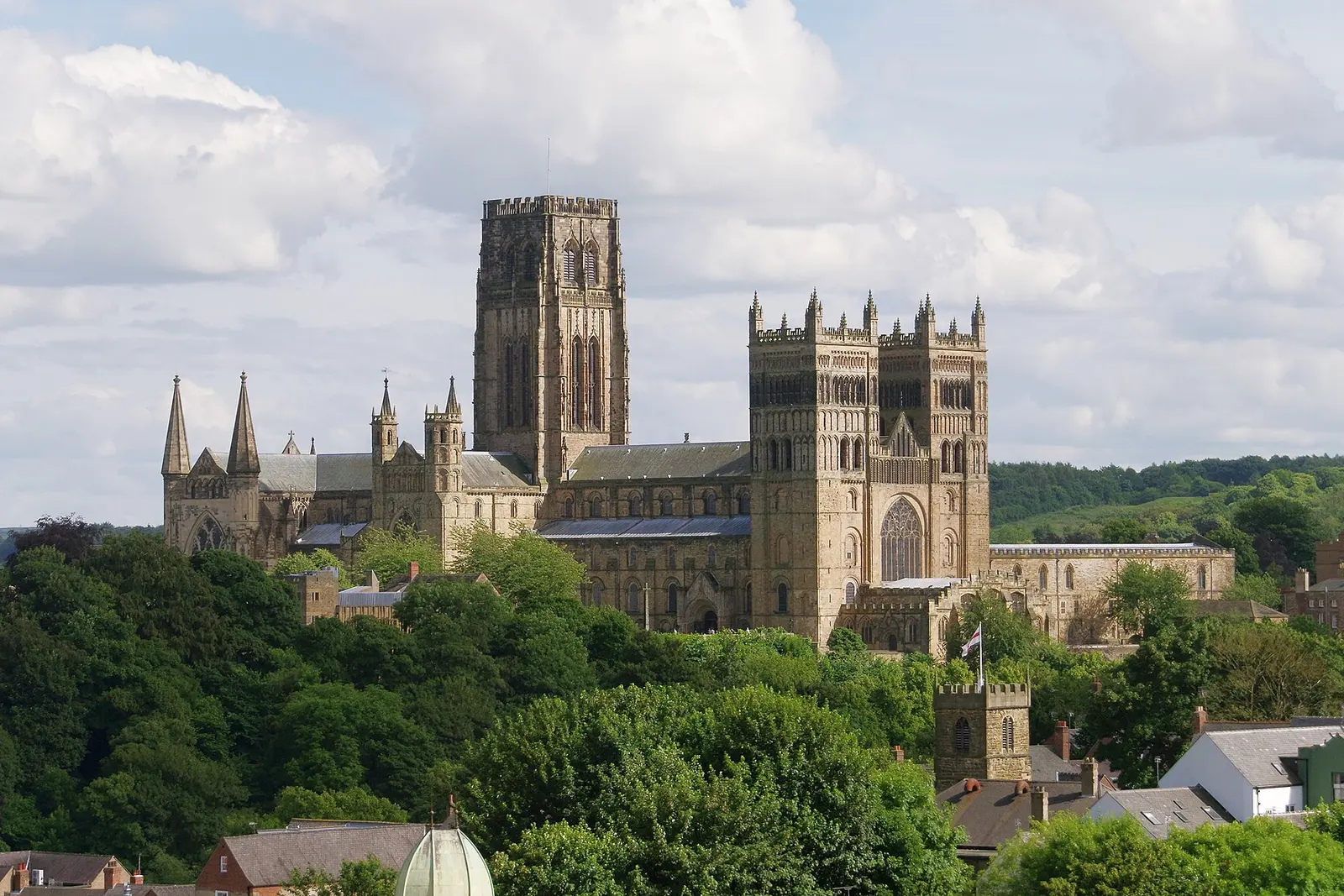 Durham Cathedral rising above trees on its riverbank peninsula