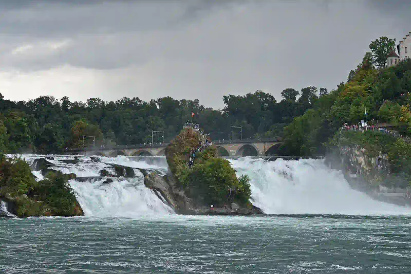 The Rhine Falls thundering past its central rocks