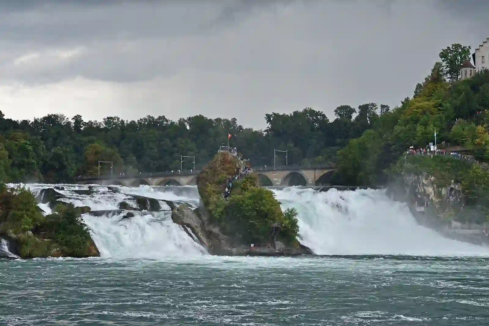 The Rhine Falls thundering past its central rocks